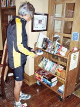 Frank Cobarrubias looking for books on the clubhouse Library’s new book cart