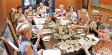 Left to right: After several hours of clipping and sorting coupons, Sheila Wyllie, Susan Simpson, Christy Caldwell, Kathi Krieg, Lois Connell, Gail Emery, Mary Beth Schmidt, Carolyn Walters, Lee Crombie and Janet Connell take a well deserved lunch break.