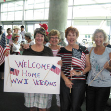 Signs welcome home the vets.