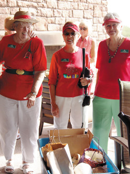 Kay Davison, Peggy McGee and Joan Harrison check out some of the donations for the Food Bank.