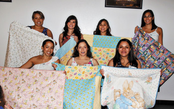 The moms who are currently serving in the National Guard got a special handmade quilt. Left to right, front row: Jennifer Magee, Gladys Rabago, Regina Mendez; back row: Jenalyn Brock, Emma Yslas, Angelica Talavera and Mia Gomez-Torres; photo by Eileen Sykora