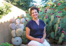 Kathy Stone sits amongst her cacti; photo by Ron Sullivan.