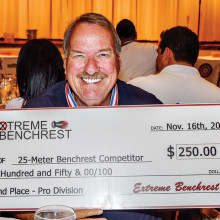 Mike Schlesinger shows off his second place, 25 yard bench rest check for $250.