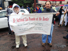 From left: Father Peter Neeley, J.S., KBI Assistant Director of Education and Shel Zantkin holding the banner in front of the Comedor that translates from Spanish: “In the Church, no one is a foreigner,” John Paul II