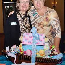 Laura Colbert and Pam Rodgers with the Noah’s Ark diaper cake designed and made by Laura with help from Sue Ellen Svik. Pam is the Chairman for the baby shower. Photo by Eileen Sykora.