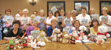 Baby shower committee with donated stuffed animals and children’s books donated by Quail Creek Canadian winter visitors; books were written by Yasmin Thorpe, a TWOQC member.