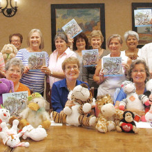 Baby shower committee with donated stuffed animals and children’s books donated by Quail Creek Canadian winter visitors; books were written by Yasmin Thorpe, a TWOQC member.