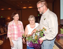 Nancy Larsen and Pam Butler learn about Lantana from Eric Clark.