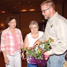 Nancy Larsen and Pam Butler learn about Lantana from Eric Clark.