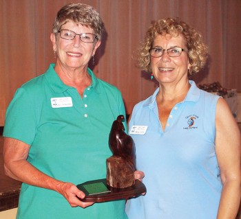 Gail Scheibner (left) with Mary Litfin, holding the Coveted Quail; photo by Sylvia Butler.