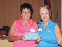 Left to right: Sally Geers was all smiles when she received the Quail Creek Star Putter brick for the lowest gross score from Lady Putters President Dee Waggoner; photo by Sylvia Butler.