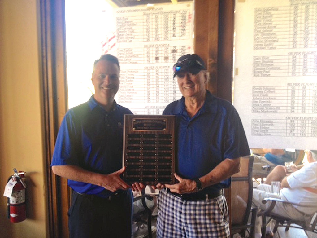 Quail Creek Men’s Golf Association 2015 Super Senior Champion Brian Kuehn receives his trophy from Head Golf Professional Joel Jaress after winning the First Super Senior Championship.