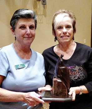 Kathy Guy receives the Coveted Quail from Dee Waggoner, Quail Creek Lady Putters president, for having the lowest net score of 29.13 during the last six-week period. Photo by Sylvia Butler