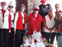 Lady Putters stand behind one of the totes that were filled with groceries destined for the Food Bank; photo by Sylvia Butler.