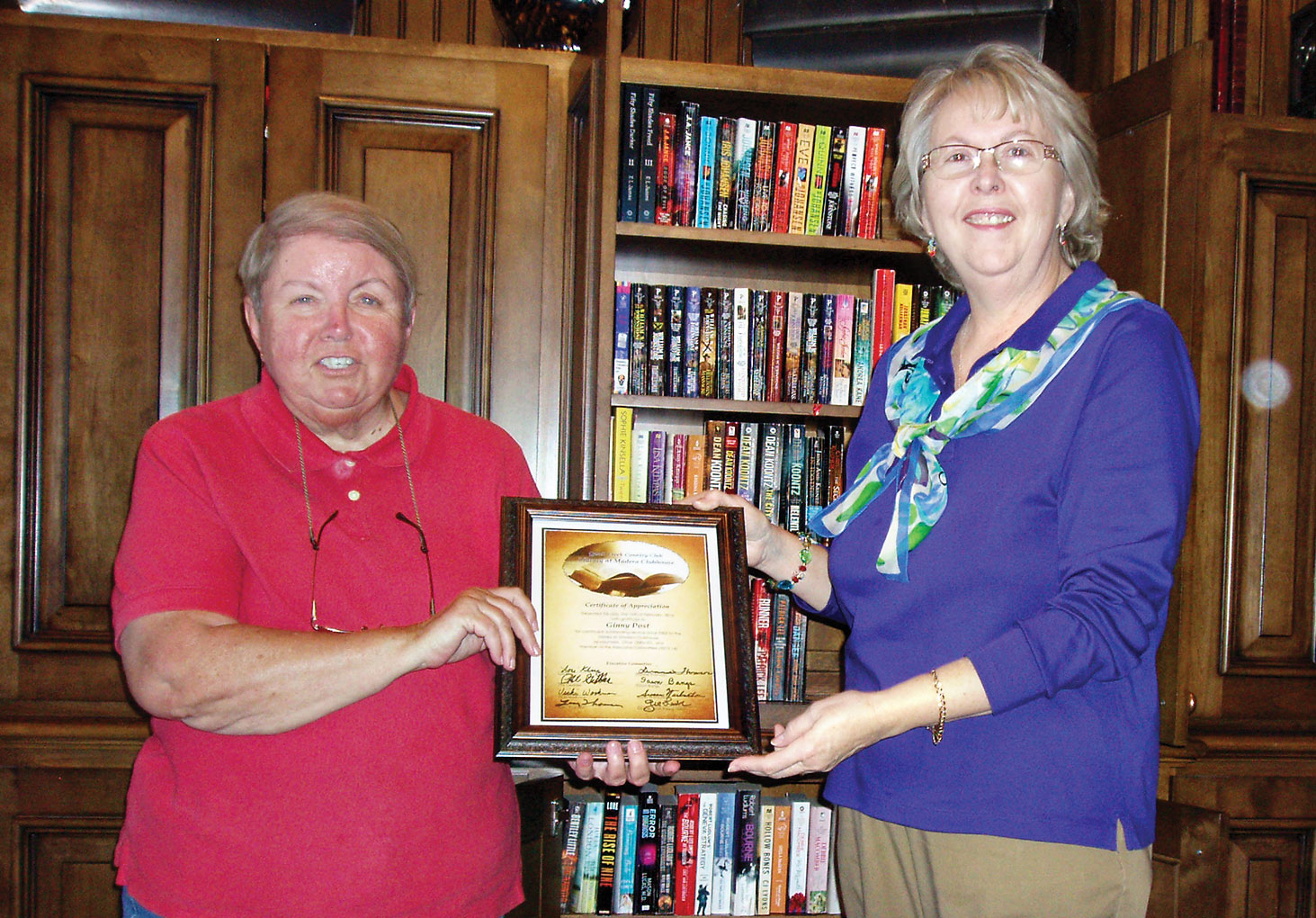 New Library Co-chair Dawn Bangs (left) presenting Certificate of Appreciation for over ten years of service to Ginny Post