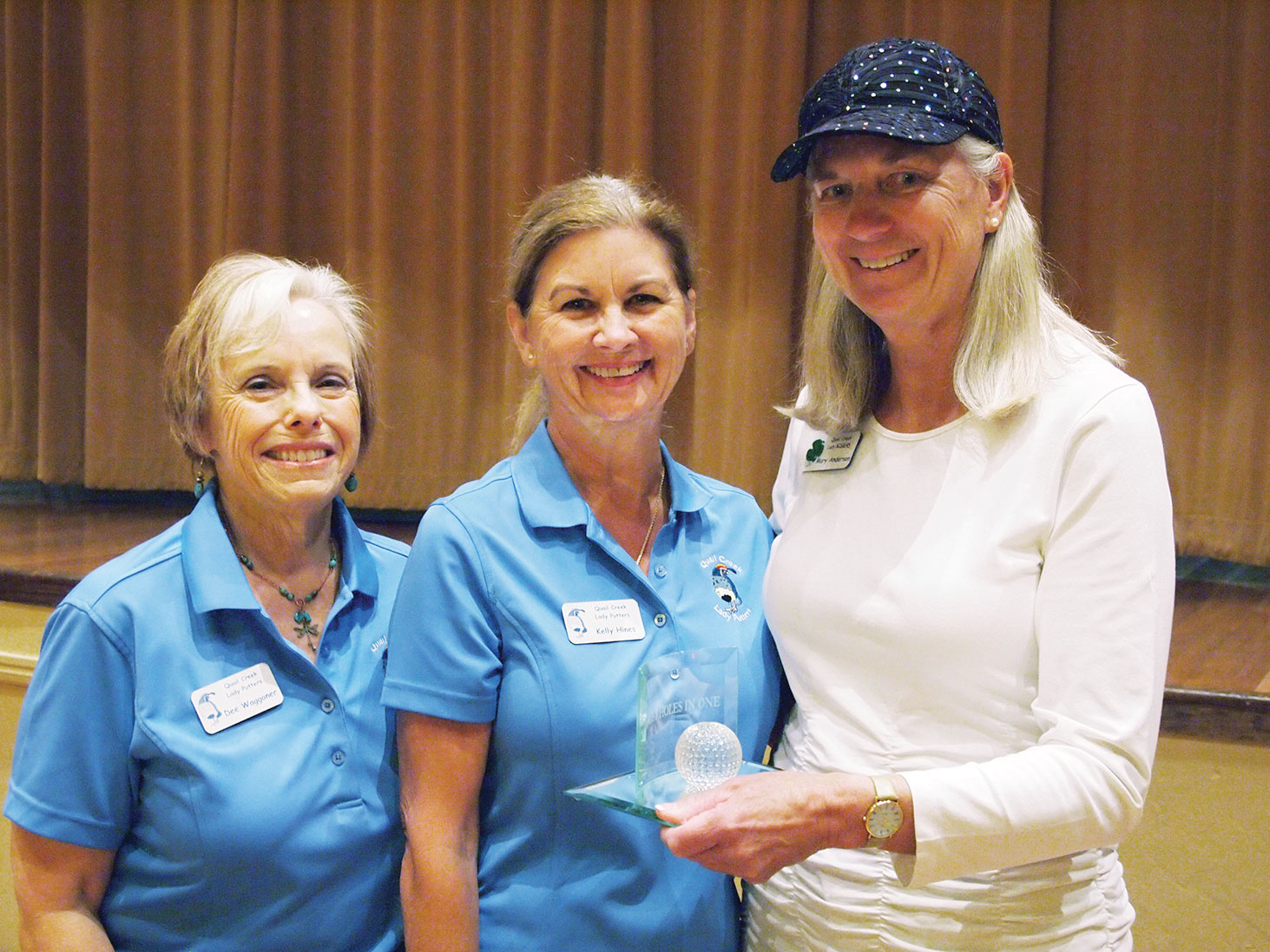 Left to right: Past President Dee Waggoner presents the Coveted Quail to Nancy Resnick for having the lowest net score for the six week period while Vice President Kelly Hines looks on; photo by Sylvia Butler.