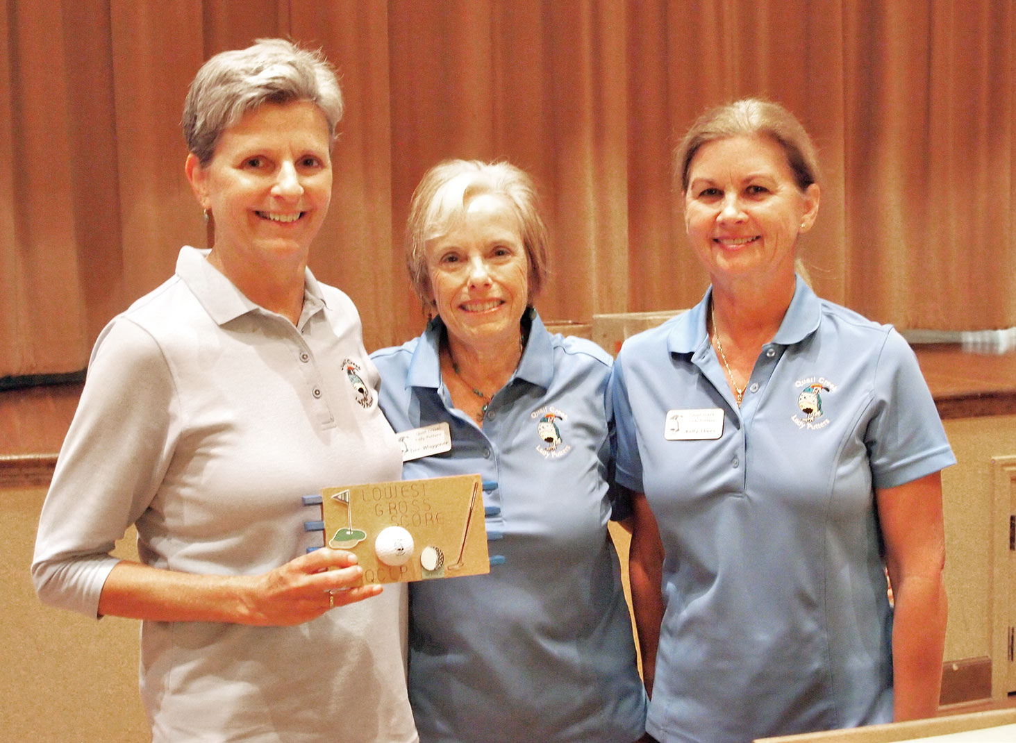 Left to right: Former Putters President Dee Waggoner and Vice President Kelly Hines present the Crystal Golf Ball to Mary Anderson for getting the most holes-in-one; photo by Sylvia Butler.