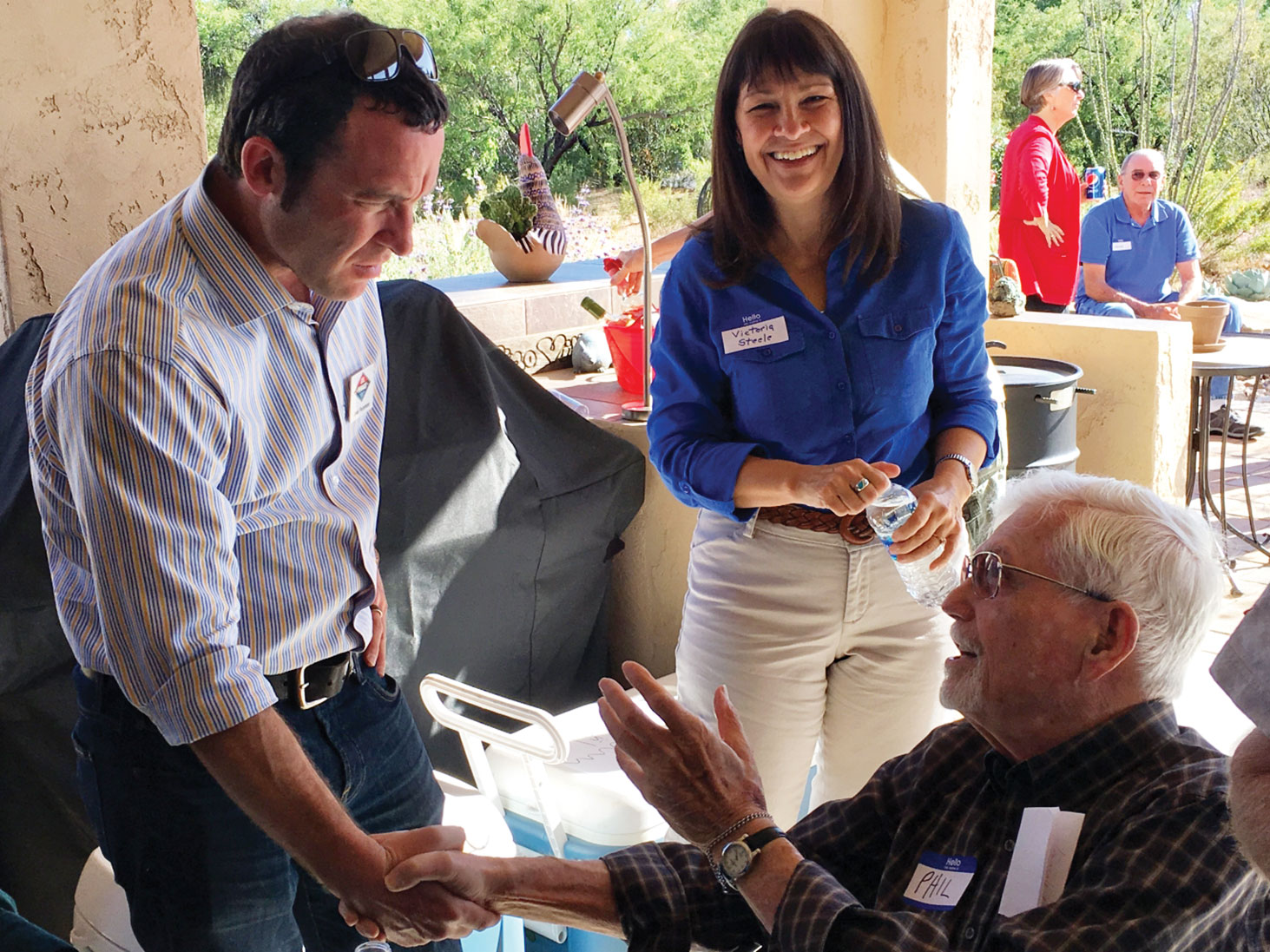 CD2 candidate Victoria Steele and Pima County Attorney candidate Joel Fineman chat with guest Phil Katz (seated).