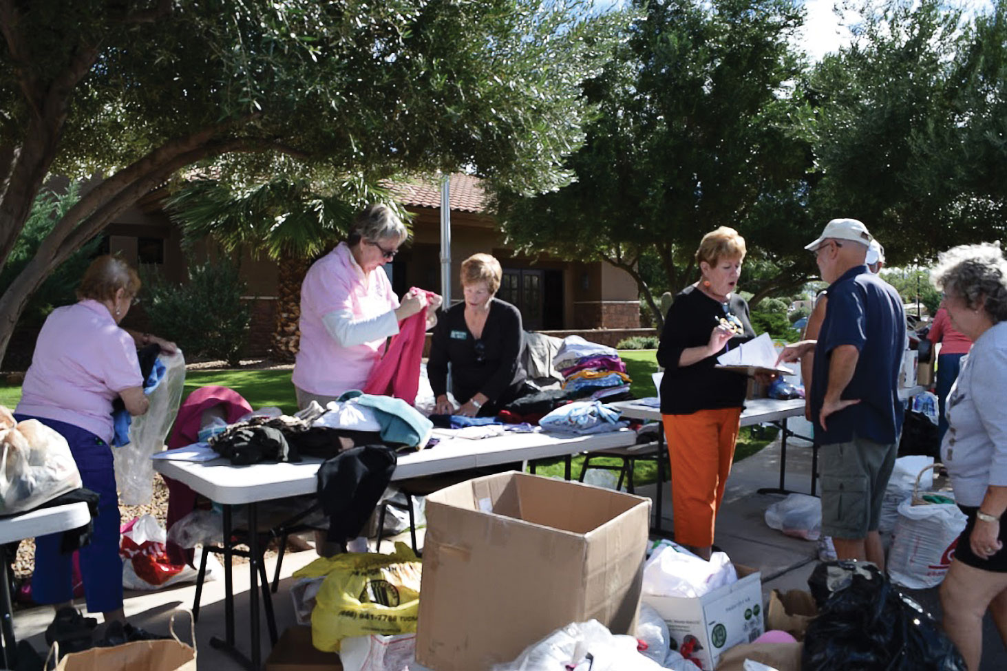 Volunteers from TWOQC gather at the Madera Clubhouse to collect, sort and bag the thousands of donated items.