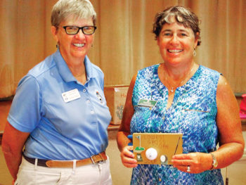 Cathy Thiele congratulates Linda Weissman who is holding the plaque she received for having the Lowest Gross Score between June 15 and August 24; photo by Sylvia Butler