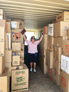 Laura Colbert, event chairperson, surrounded by some of the items delivered to the VA; photo by Jerry Colbert