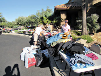 TWOQC volunteers sorting men’s and women’s clothing donations; photo by Diane Quinn