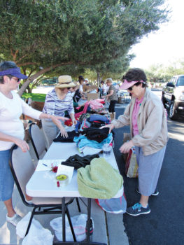 More volunteers sort through donations; photo by Diane Quinn