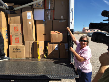 Event Chairperson Laura Colbert presents a truckload of donations to the VA; photo by Jerry Colbert