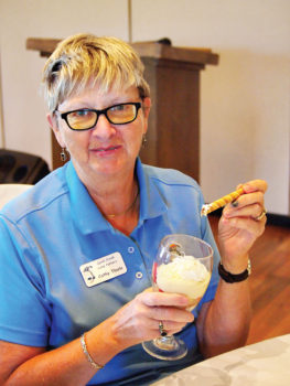 Putters President Cathy Thiele enjoys a strawberry parfait on her birthday; photo by Sylvia Butler