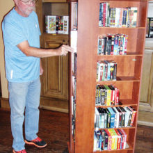 Longtime donations coordinator Phil Geddes at the audio book-DVD movie carousel
