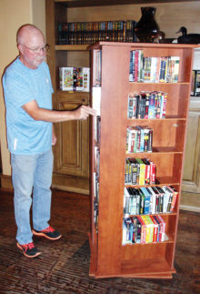 Longtime donations coordinator Phil Geddes at the audio book-DVD movie carousel
