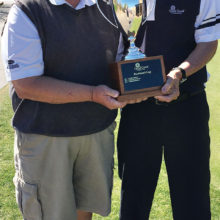 Tim Phillips, president of the QCMGA, presents the President’s Cup trophy to the 2017 winner - Paul Athey