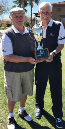 Tim Phillips, president of the QCMGA, presents the President’s Cup trophy to the 2017 winner - Paul Athey