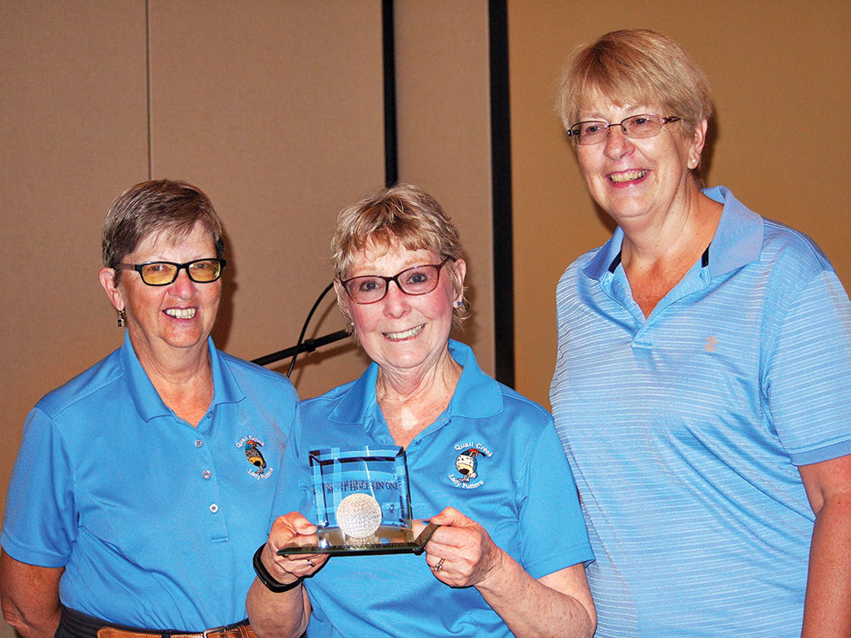 Left to right: Putters President Cathy Thiele presents the Crystal Golf Ball plaque to Bev Wake while Janet Wegner looks on; photo by Sylvia Butler.
