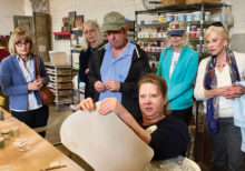 Donna Stoner demonstrates how to make clay the correct leather-like consistency and thickness for cutting shapes. The shapes, when finished, will become part of one of Santa Teresa’s colorful mosaics.