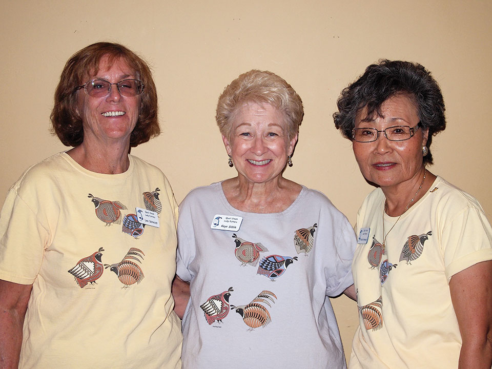 Left to right: Lee Schmidt, Kaye Siblik, and Yoshie Hennessy model the original putters’ shirts (front and back); photo by Sylvia Butler.