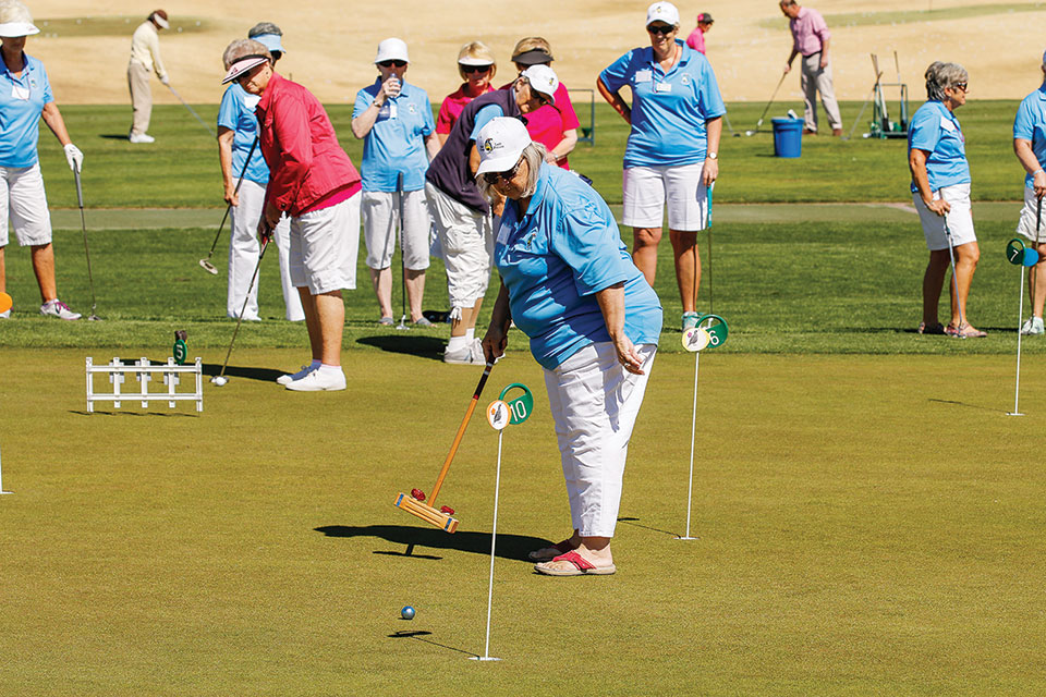 Considering she had to use a croquet mallet instead of a putter, Sylvia Butler came pretty close to the hole on her first putt; photo by Jim Burkstrand.