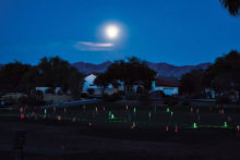 The full moon shown over the putting green; photo by Jim Burkstrand.