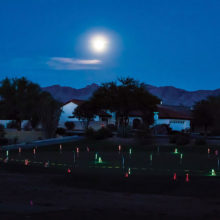 The full moon shown over the putting green; photo by Jim Burkstrand.