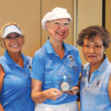 Joyce Walton holds the Crystal Golf Ball plaque flanked by Diane Dodd (left) and Yoshie Hennessy. Each will be able to take the plaque home for three weeks to show it off to family and friends; photo by Sylvia Butler.