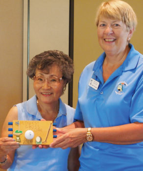 Left to right: Yoshie Hennessy is presented the plaque for the low gross score by Putters Vice President Janet Wegner; photo by Sylvia Butler.