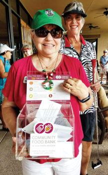 Suzan Bryceland holds the container with $565 to help the Food Bank; photo by Peggy McGee