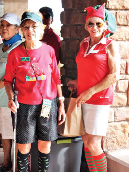 Left to right: Peggy McGee and Diane Dodd wore holiday socks despite the 90 plus temperatures; photo by Sylvia Butler