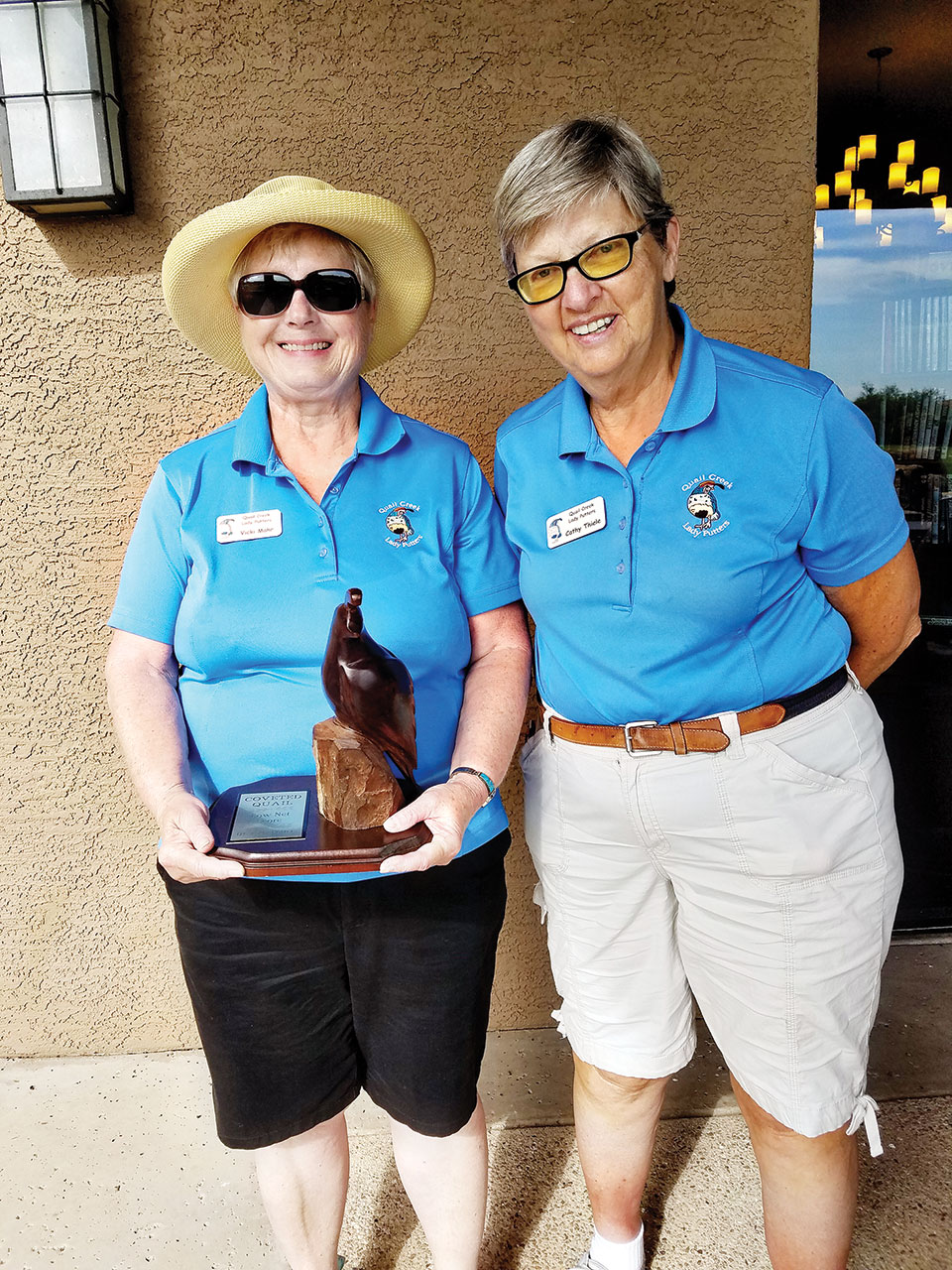 Left to right: Vicki Mahr is all smiles as Putters President Cathy Thiele presents her with the Coveted Quail Award. Vicki had a low net score of 32.5 for the May through June timeframe. This is the first time in her 10 years as a Putter that Vicki has ever won an award; photo by Peggy McGee.