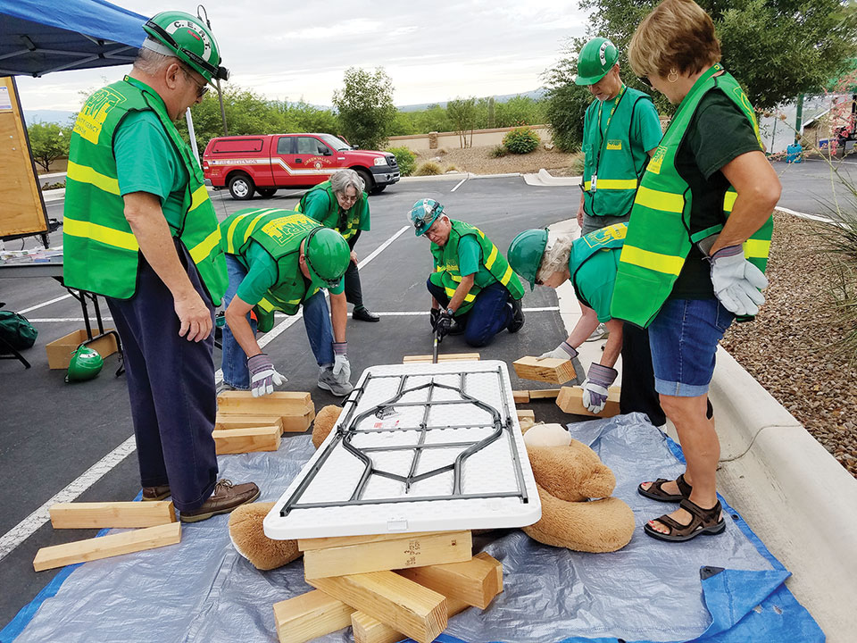 CERT members practice cribbing techniques to rescue a victim trapped under rubble. Photo by Peggy McGee