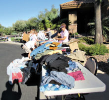 Volunteers sort men’s clothing during last year’s drive. Photo by Eileen Sykora