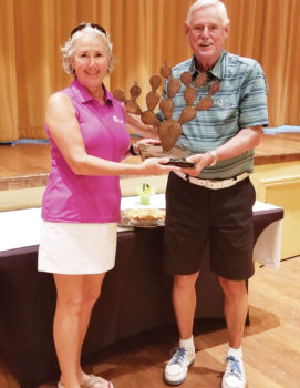 Tim Phillips, president of the QCMGA, presents Chris Gould, president of the QCLGA, the Prickly Pair Trophy.
