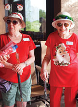 Emilie Ortega (left) and Fay Shapiro wore holiday headgear when they putted at Christmas in July. Photo by Sylvia Butler.