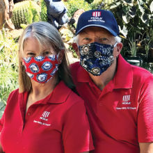 MOAA members Myra and Jeff McCune, both U.S. Navy retirees, model the masks in the two different patterns available for the Navy. (Photo by Bruce Hilt)