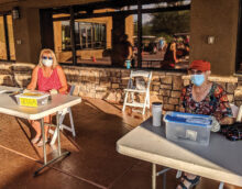 Sign in table: (left) Deb Riddell, tournament chair (right) Sandi Hrovatin, treasurer